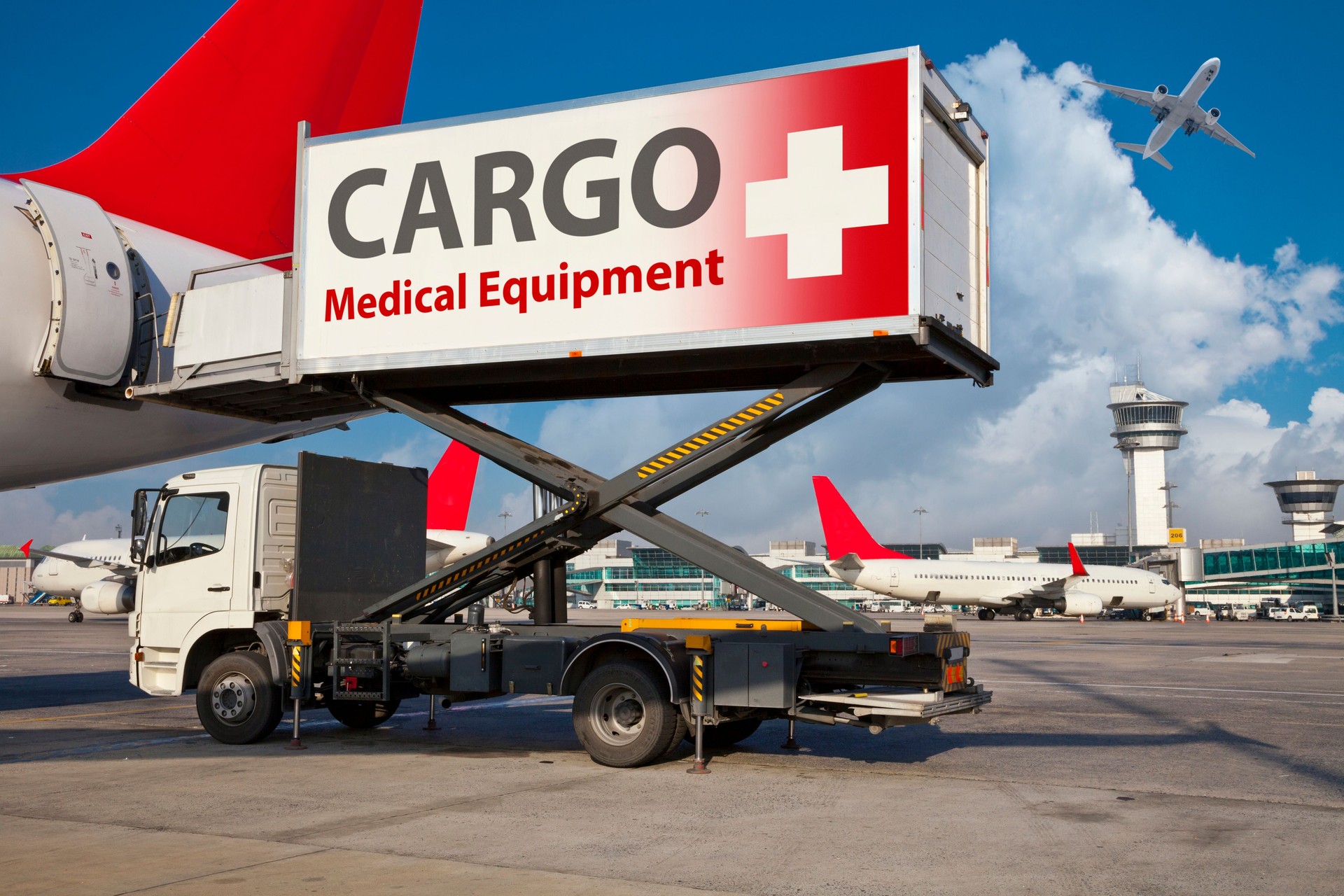 Airport highloader loading medical equipment cargo into airplane